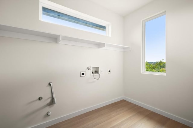 1817 High Lonesome, Leander, TX 78641 - laundry room featuring hookup for an electric dryer, hookup for a washing machine, light wood-type flooring, and gas dryer hookup