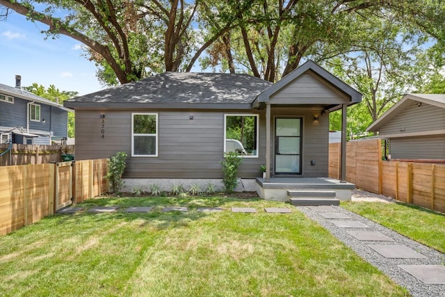 3704 Munson St Unit 1, Austin, TX 78721 - view of front of property with a fenced backyard and a shingled roof