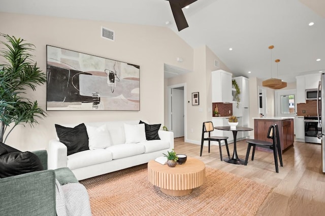3704 Munson St Unit 1, Austin, TX 78721 - living room featuring light wood finished floors, lofted ceiling, ceiling fan, and recessed lighting