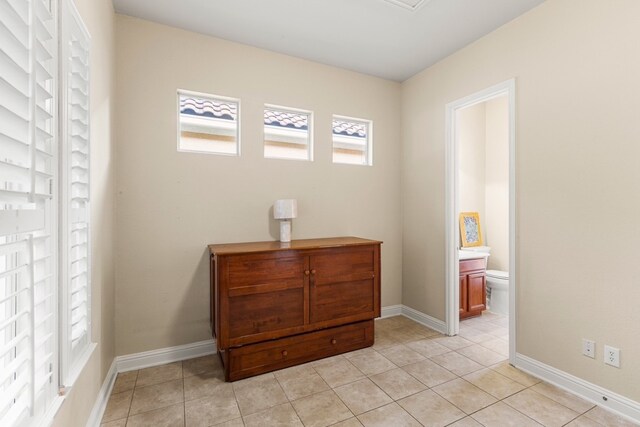 15325 Interlachen Dr, Austin, TX 78717 - bedroom featuring light tile patterned flooring and connected bathroom