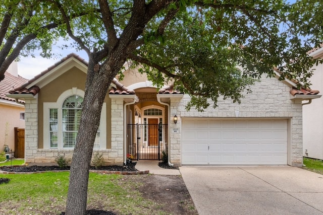 15325 Interlachen Dr, Austin, TX 78717 - view of front facade with stone siding, concrete driveway, and a garage