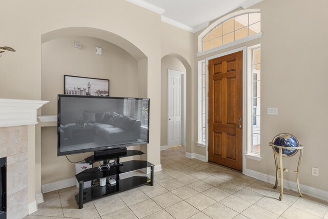 15325 Interlachen Dr, Austin, TX 78717 - foyer entrance with light tile patterned floors, crown molding, a tiled fireplace, arched walkways, and healthy amount of natural light