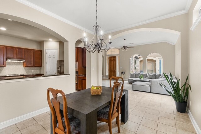 15325 Interlachen Dr, Austin, TX 78717 - dining room with arched walkways, light tile patterned flooring, ceiling fan, a chandelier, and ornamental molding