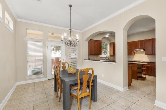 15325 Interlachen Dr, Austin, TX 78717 - dining area featuring light tile patterned floors, a chandelier, and crown molding