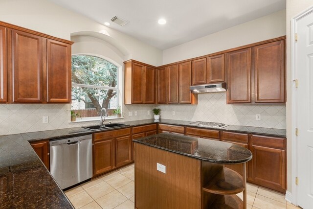 15325 Interlachen Dr, Austin, TX 78717 - kitchen featuring stainless steel appliances, open shelves, under cabinet range hood, light tile patterned floors, and dark stone counters