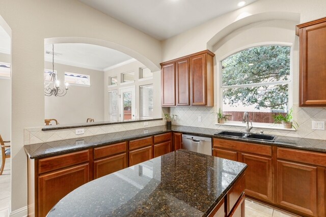 15325 Interlachen Dr, Austin, TX 78717 - kitchen with stainless steel dishwasher, dark stone counters, tasteful backsplash, arched walkways, and crown molding