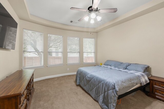 15325 Interlachen Dr, Austin, TX 78717 - bedroom featuring light colored carpet, a raised ceiling, and a ceiling fan