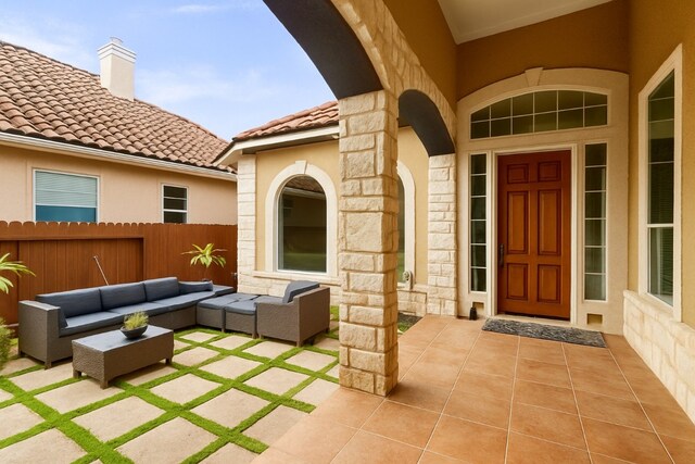 15325 Interlachen Dr, Austin, TX 78717 - property entrance with stone siding, an outdoor living space, a patio, stucco siding, and a tiled roof