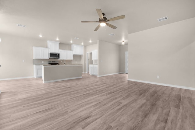 817 Coke Rd, Burnet, TX 78611 - unfurnished living room with recessed lighting, light wood-type flooring, and a ceiling fan