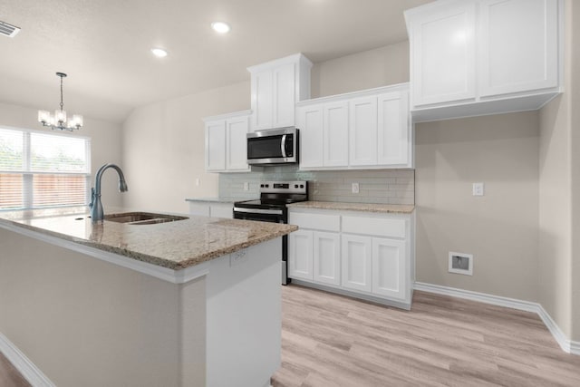 817 Coke Rd, Burnet, TX 78611 - kitchen with stainless steel appliances, tasteful backsplash, white cabinets, light wood finished floors, and recessed lighting