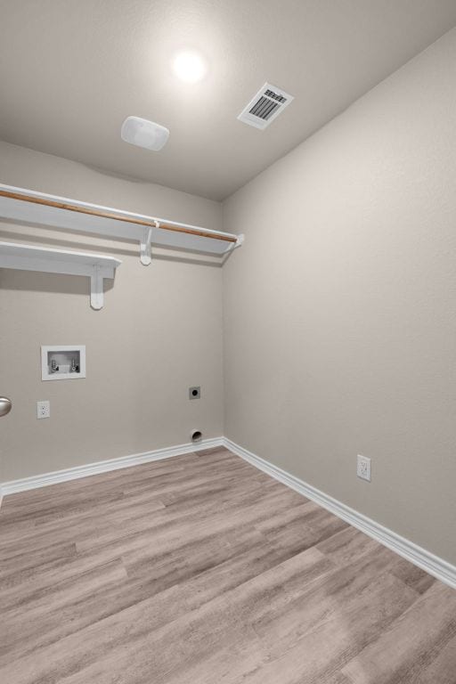 817 Coke Rd, Burnet, TX 78611 - washroom featuring hookup for an electric dryer, hookup for a washing machine, and light wood finished floors