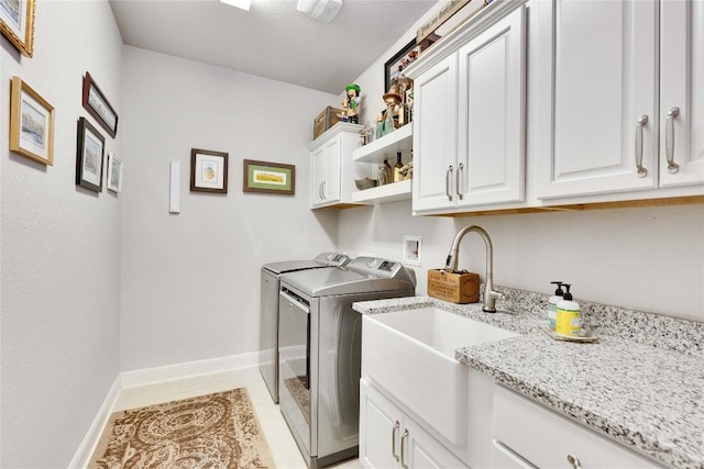 2817 Mossy Springs Dr, Leander, TX 78641 - washroom featuring cabinet space, washing machine and clothes dryer, and light tile patterned floors