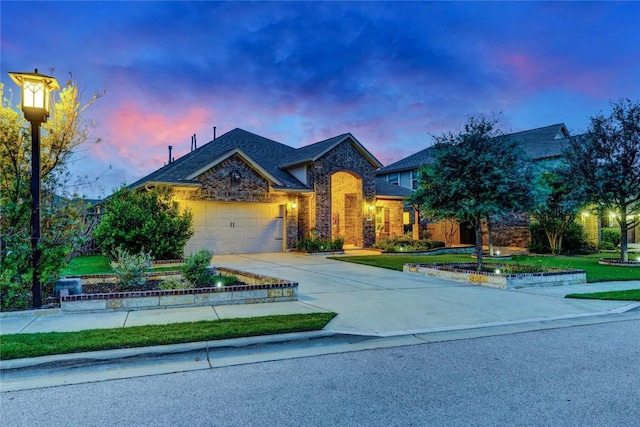 2817 Mossy Springs Dr, Leander, TX 78641 - view of front of house with an attached garage, concrete driveway, and brick siding