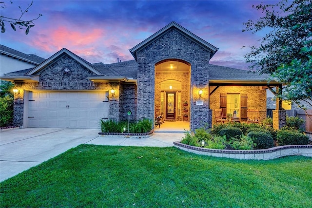 2817 Mossy Springs Dr, Leander, TX 78641 - view of front facade featuring brick siding, an attached garage, a lawn, and concrete driveway