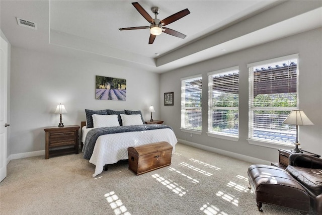 2817 Mossy Springs Dr, Leander, TX 78641 - bedroom featuring multiple windows, light carpet, a raised ceiling, and ceiling fan