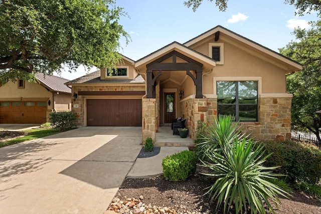 29 Prestonwood Cir, Lakeway, TX 78734 - view of front facade with stone siding, an attached garage, concrete driveway, and stucco siding
