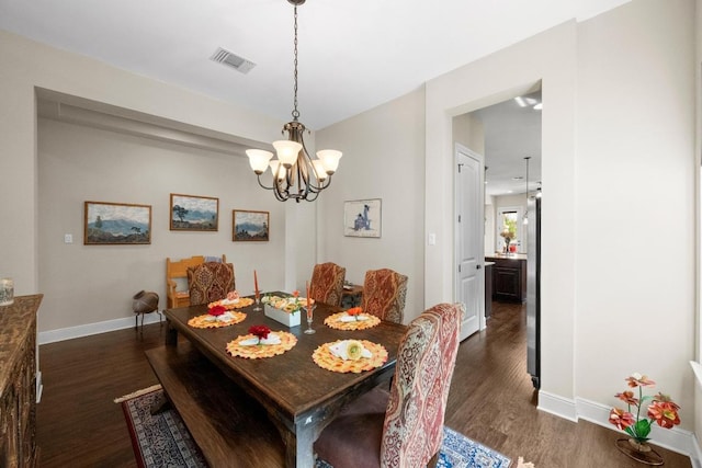 29 Prestonwood Cir, Lakeway, TX 78734 - dining area with a chandelier and dark wood-style floors
