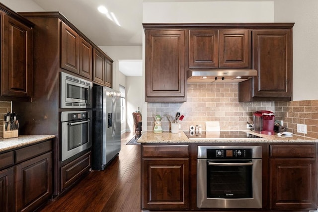 29 Prestonwood Cir, Lakeway, TX 78734 - kitchen with stainless steel appliances, under cabinet range hood, dark brown cabinets, dark wood-type flooring, and backsplash