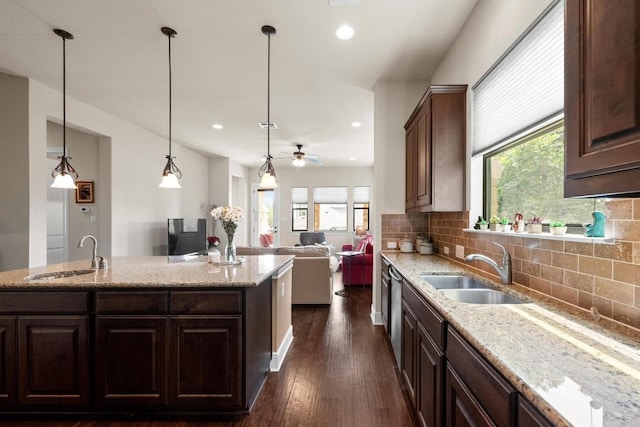 29 Prestonwood Cir, Lakeway, TX 78734 - kitchen featuring backsplash, light stone counters, dark wood finished floors, recessed lighting, and open floor plan