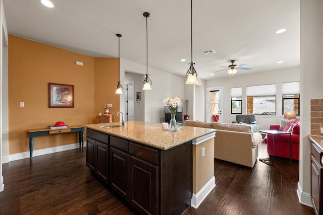 29 Prestonwood Cir, Lakeway, TX 78734 - kitchen featuring dark wood-type flooring, recessed lighting, ceiling fan, a kitchen island with sink, and light stone countertops