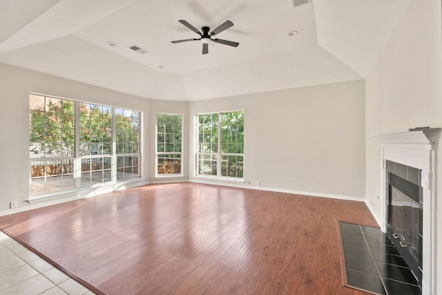 11208 Cedarcliffe Dr, Austin, TX 78750 - unfurnished living room featuring a tile fireplace, plenty of natural light, a ceiling fan, and wood finished floors