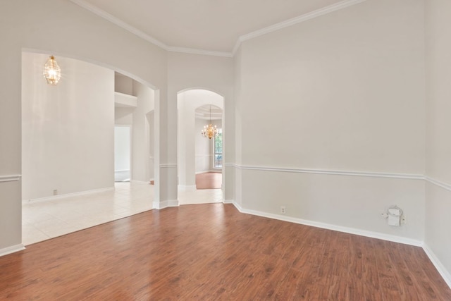 11208 Cedarcliffe Dr, Austin, TX 78750 - spare room with a chandelier, arched walkways, wood finished floors, and crown molding