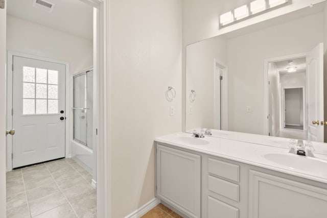 11208 Cedarcliffe Dr, Austin, TX 78750 - full bathroom featuring double vanity, tile patterned floors, and bath / shower combo with glass door