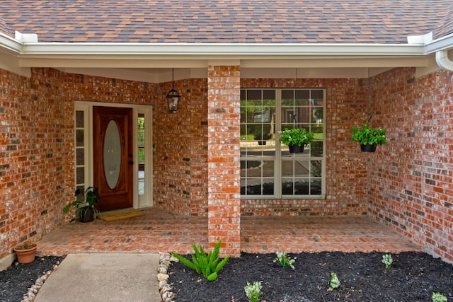 11208 Cedarcliffe Dr, Austin, TX 78750 - doorway to property featuring brick siding and a shingled roof