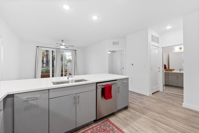 4801 Springdale Dr Unit 2010, Austin, TX 78723 - kitchen with stainless steel dishwasher, gray cabinets, light wood-style floors, light countertops, and recessed lighting