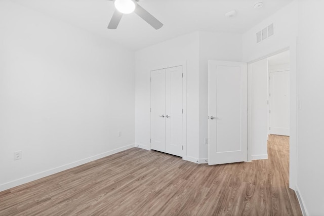 4801 Springdale Dr Unit 2010, Austin, TX 78723 - unfurnished bedroom featuring wood finished floors, a closet, and ceiling fan