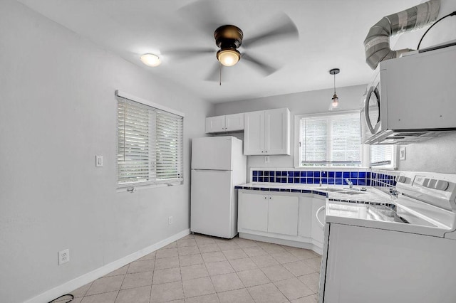 15102 Iowa St, Austin, TX 78734 - kitchen with white appliances, white cabinets, ceiling fan, tile countertops, and light tile patterned flooring