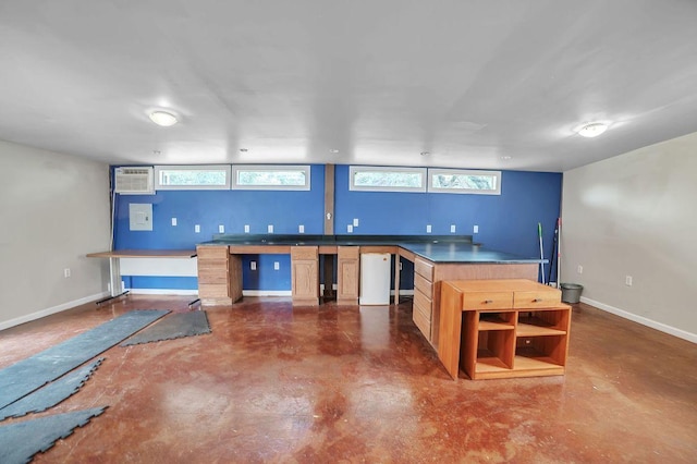 15102 Iowa St, Austin, TX 78734 - kitchen with concrete flooring, a wall unit AC, healthy amount of natural light, and dark countertops