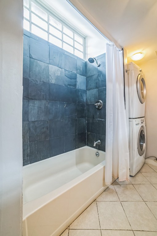15102 Iowa St, Austin, TX 78734 - full bathroom featuring stacked washer / drying machine, shower / bathtub combination with curtain, and tile patterned floors