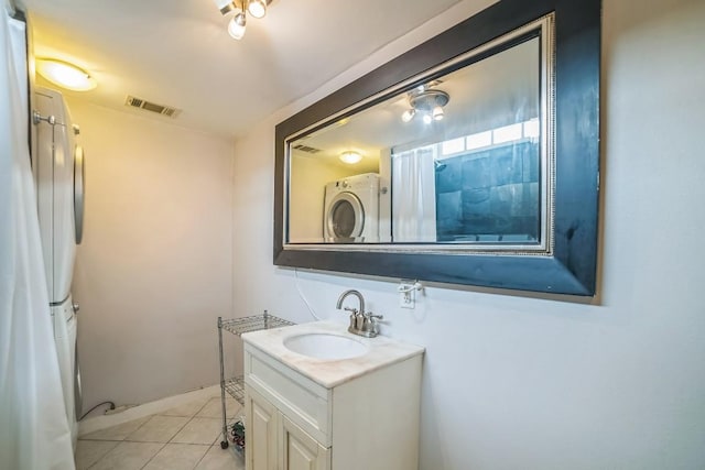 15102 Iowa St, Austin, TX 78734 - bathroom with stacked washer / dryer, vanity, and tile patterned flooring