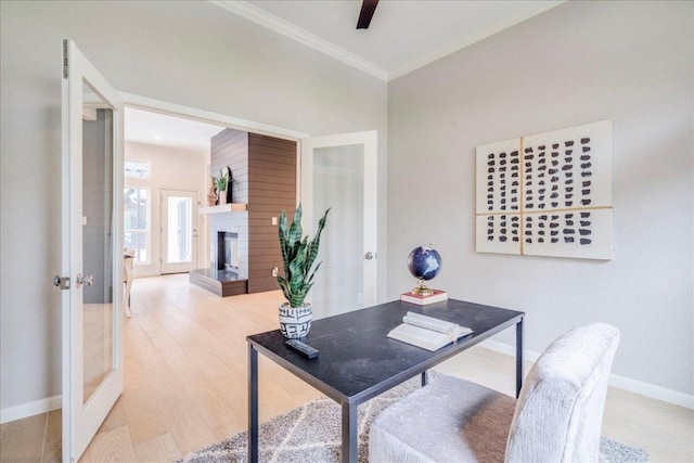 9110 Scotsman Dr, Austin, TX 78750 - home office featuring crown molding, wood finished floors, a fireplace with raised hearth, and french doors