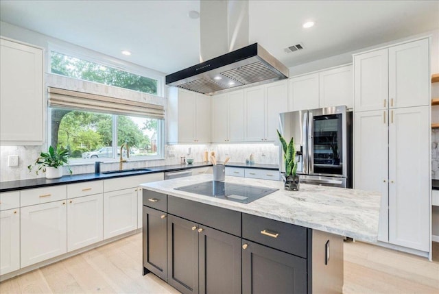 9110 Scotsman Dr, Austin, TX 78750 - kitchen featuring wall chimney exhaust hood, appliances with stainless steel finishes, white cabinetry, tasteful backsplash, and recessed lighting