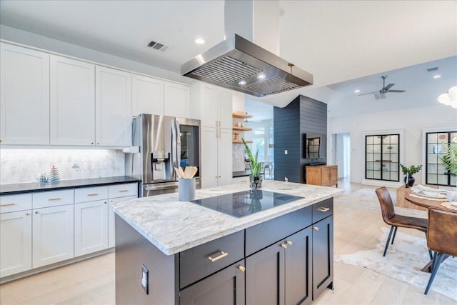 9110 Scotsman Dr, Austin, TX 78750 - kitchen with stainless steel fridge, extractor fan, black electric stovetop, recessed lighting, and ceiling fan