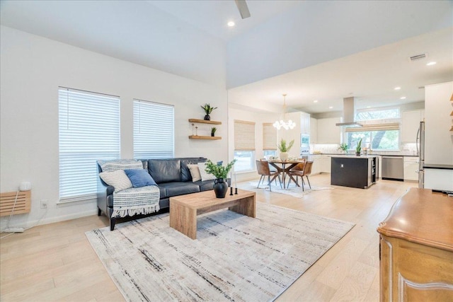 9110 Scotsman Dr, Austin, TX 78750 - living area featuring light wood-style flooring, a chandelier, and recessed lighting