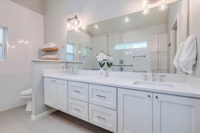 9110 Scotsman Dr, Austin, TX 78750 - bathroom featuring a stall shower, double vanity, and tile patterned flooring