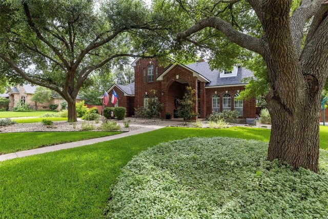 35 Forest Mesa, Round Rock, TX 78664 - view of front of property with brick siding, a front yard, and a shingled roof