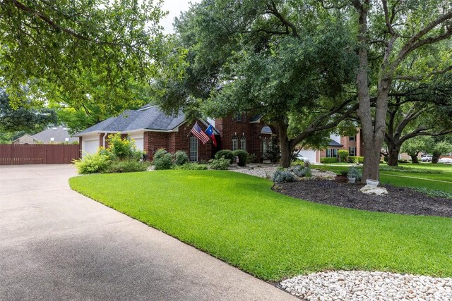35 Forest Mesa, Round Rock, TX 78664 - view of front facade with concrete driveway, a garage, and brick siding