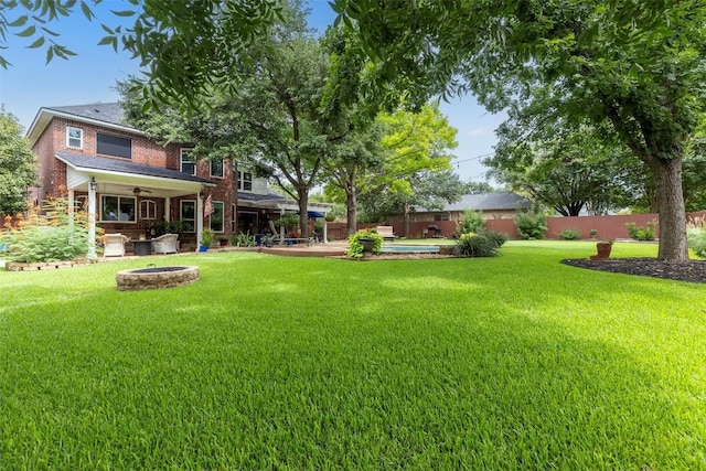 35 Forest Mesa, Round Rock, TX 78664 - fenced backyard featuring a fire pit, a ceiling fan, and a patio