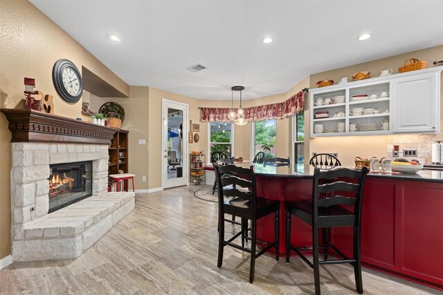 35 Forest Mesa, Round Rock, TX 78664 - dining space featuring recessed lighting, a fireplace, a chandelier, and light wood-type flooring