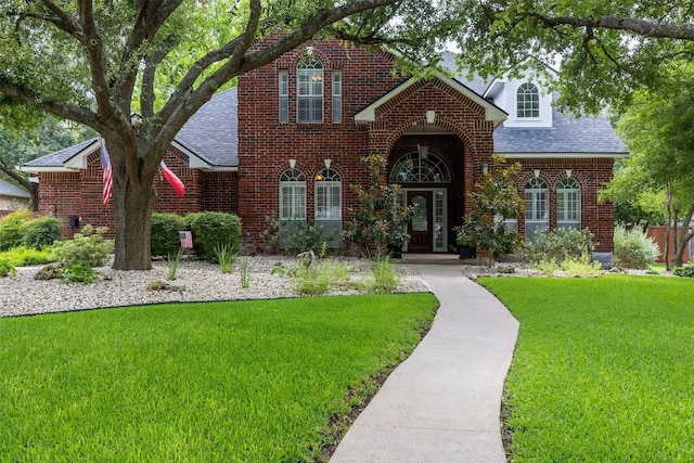 35 Forest Mesa, Round Rock, TX 78664 - view of front of home featuring a shingled roof, a front lawn, and brick siding