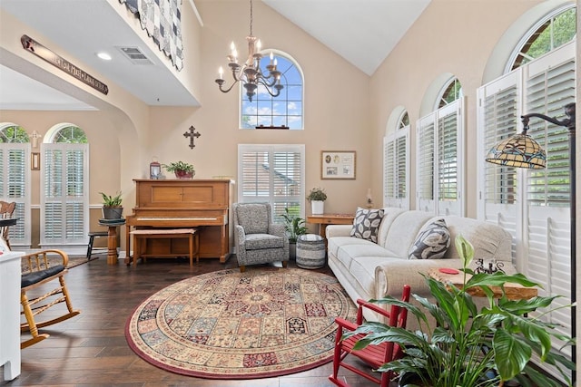 35 Forest Mesa, Round Rock, TX 78664 - living area with plenty of natural light, dark wood finished floors, a chandelier, and high vaulted ceiling