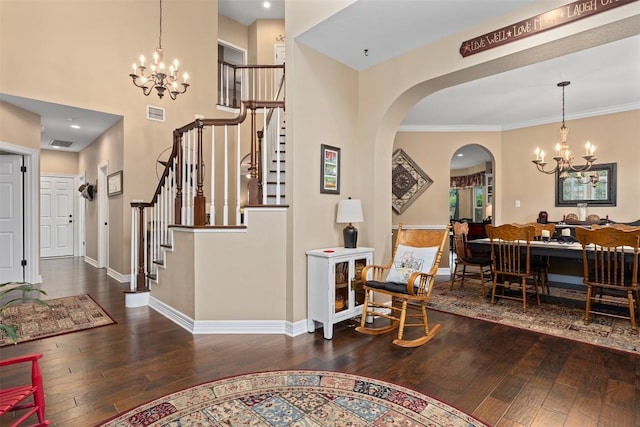 35 Forest Mesa, Round Rock, TX 78664 - entrance foyer with a chandelier, hardwood / wood-style floors, stairs, arched walkways, and a high ceiling