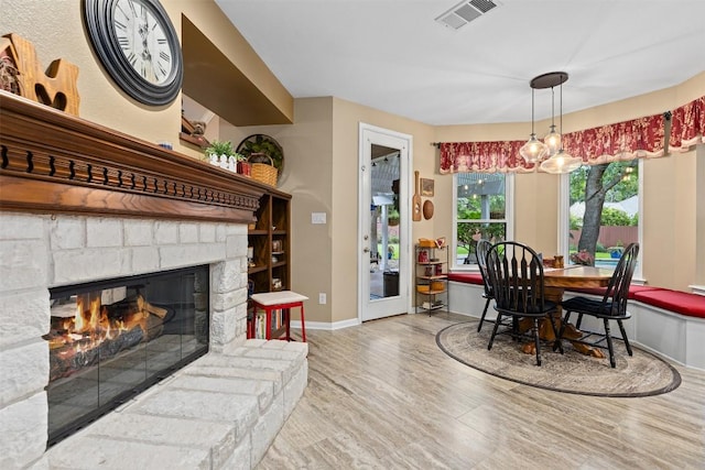 35 Forest Mesa, Round Rock, TX 78664 - dining room with wood finished floors and a stone fireplace