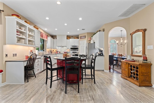 35 Forest Mesa, Round Rock, TX 78664 - dining room with a chandelier, light wood finished floors, and recessed lighting