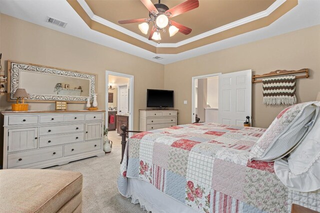 35 Forest Mesa, Round Rock, TX 78664 - bedroom featuring light carpet, a tray ceiling, ornamental molding, ceiling fan, and connected bathroom