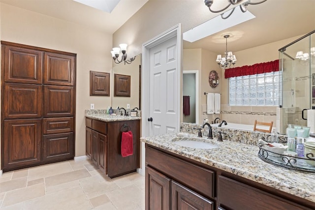 35 Forest Mesa, Round Rock, TX 78664 - full bathroom with a chandelier, a stall shower, two vanities, and a bath